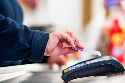 person using a debit card to pay for a purchase